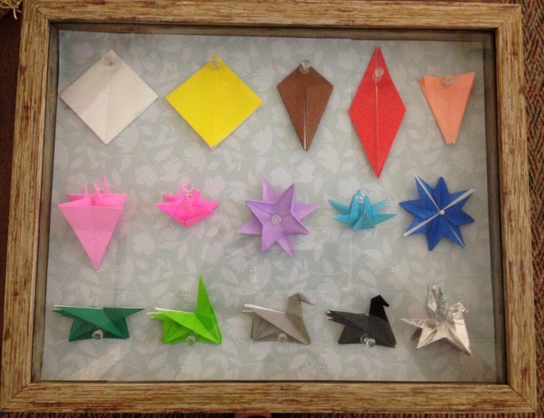 Fold progression of origami pegasus in 15 pieces of paper mounted in a shadow box